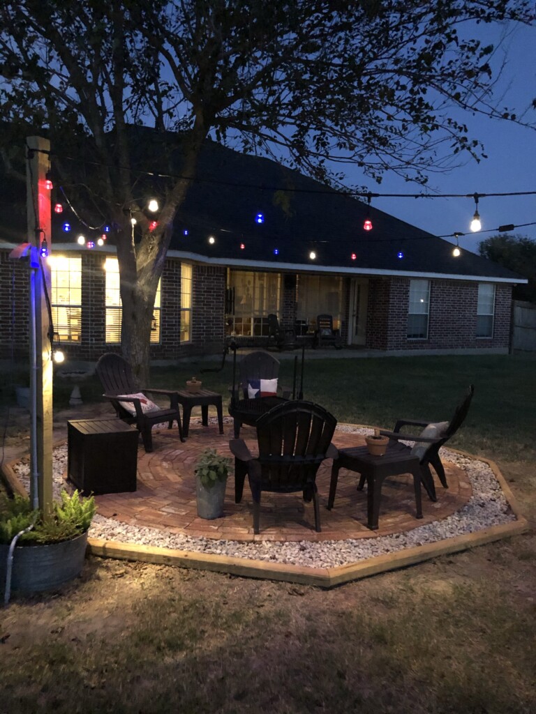 sitting area with fire pit and lights