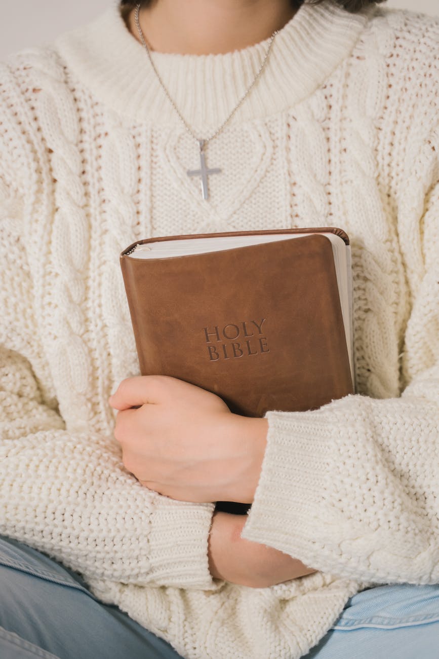 person holding a Bible with life applications
