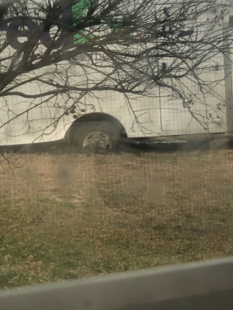 delivery truck stuck in a rut in a yard
