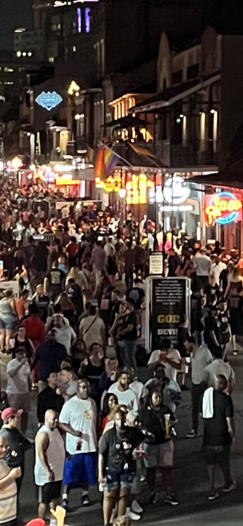 crowd on Bourbon Street with people witnessing