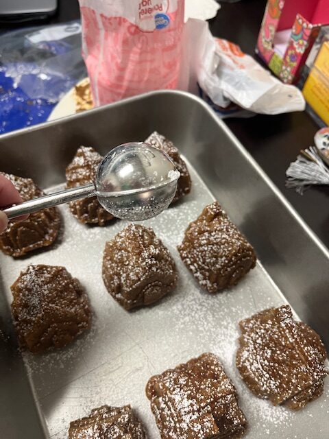 powdered sugar on the gingerbread cakes to make snow