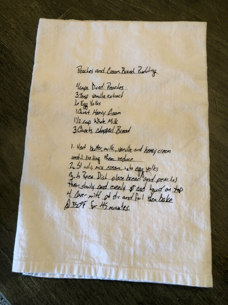Handwritten family recipe for peaches and cream bread pudding on a piece of stained paper, including ingredients and instructions.
