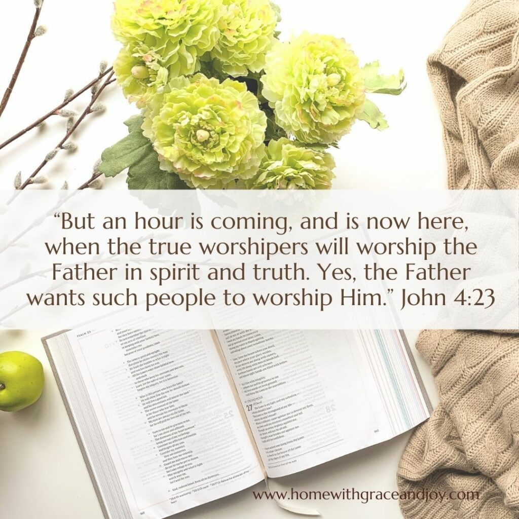 A Bible open to a page underneath a transparent sheet with John 4:23 written on it. Beside the Bible is a light green granny smith apple, some green and white hydrangeas, and a textured beige cloth. Text reads, "But an hour is coming, and is now here..." Life Applications noted.